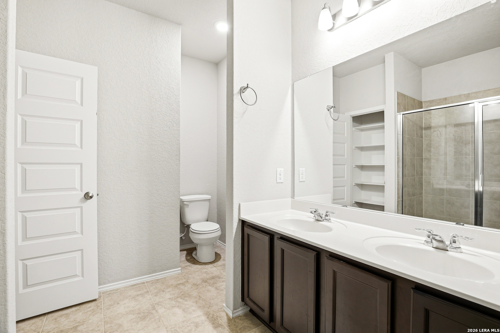 5314 Riley Way St. Hedwig, TX 78152 - Photo 7 of 26 a bathroom with a double vanity sink and a mirror