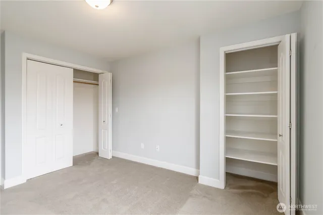 a view of an empty room with a closet