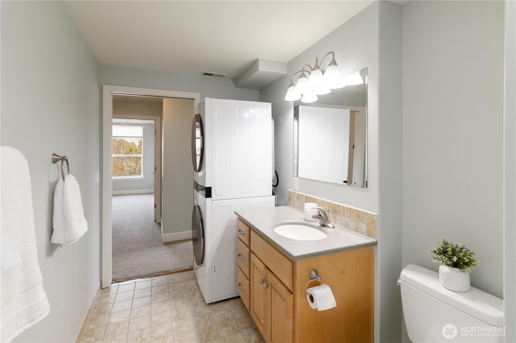 1548 River Road, Unit 302 Longview, WA 98632 - Photo 14 of 37 a bathroom with a double vanity sink mirror and toilet