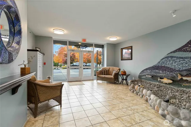 a bedroom with furniture and a large window