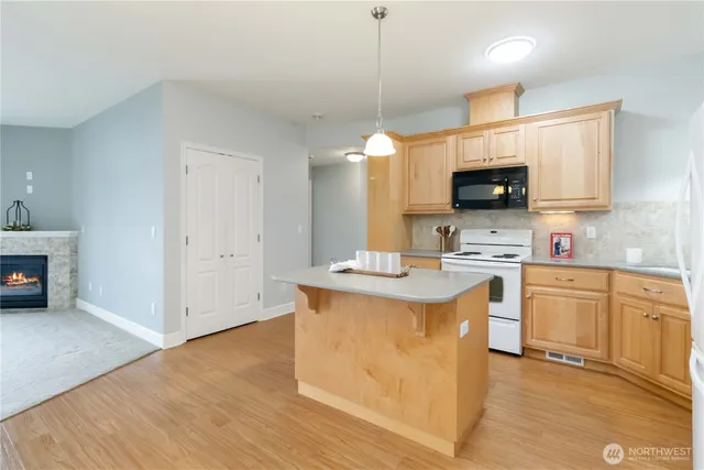 a kitchen with stainless steel appliances granite countertop a sink stove and microwave