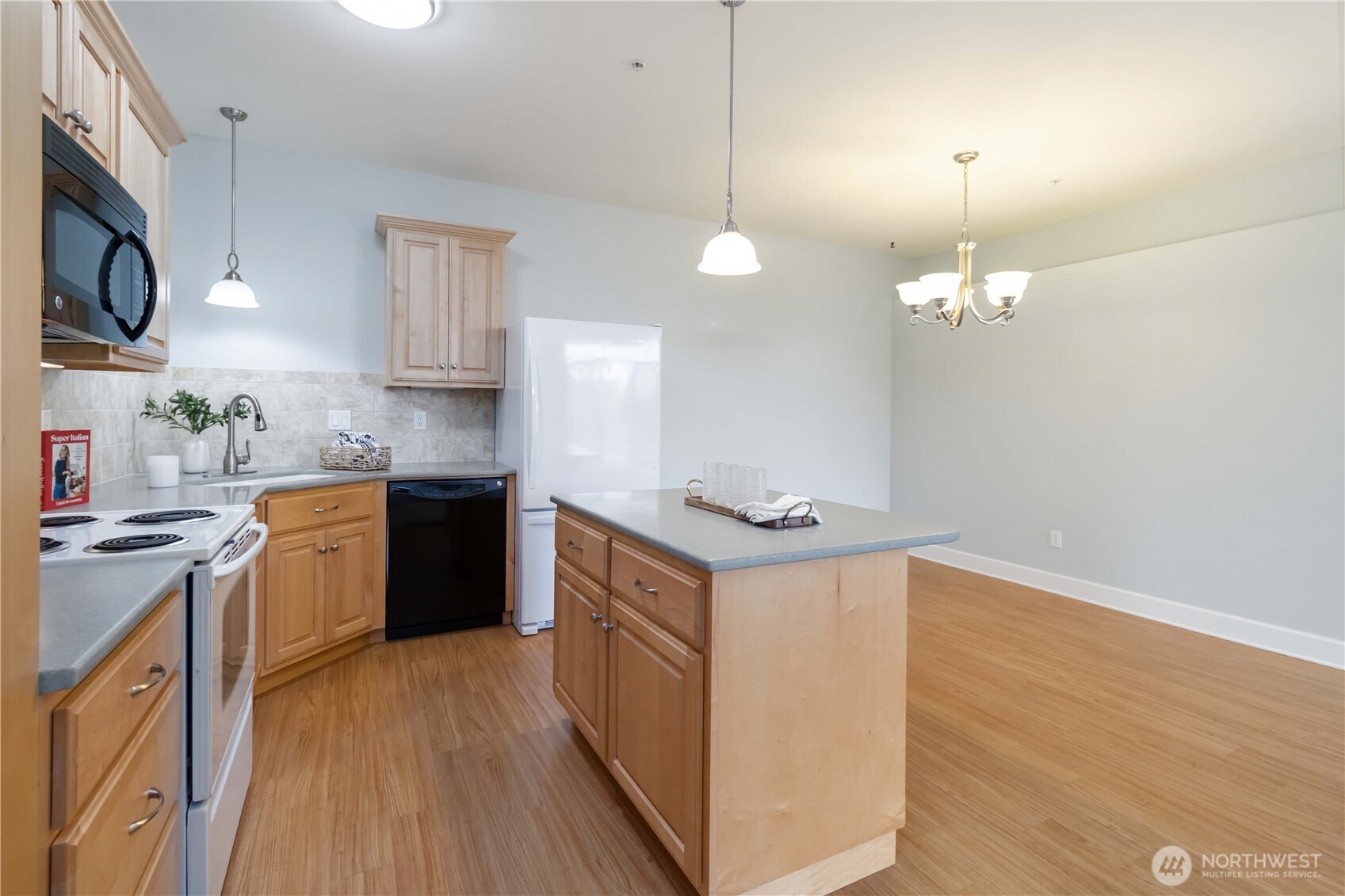 1548 River Road, Unit 302 Longview, WA 98632 - Photo 9 of 37 a kitchen with stainless steel appliances granite countertop a sink a stove and a wooden floors