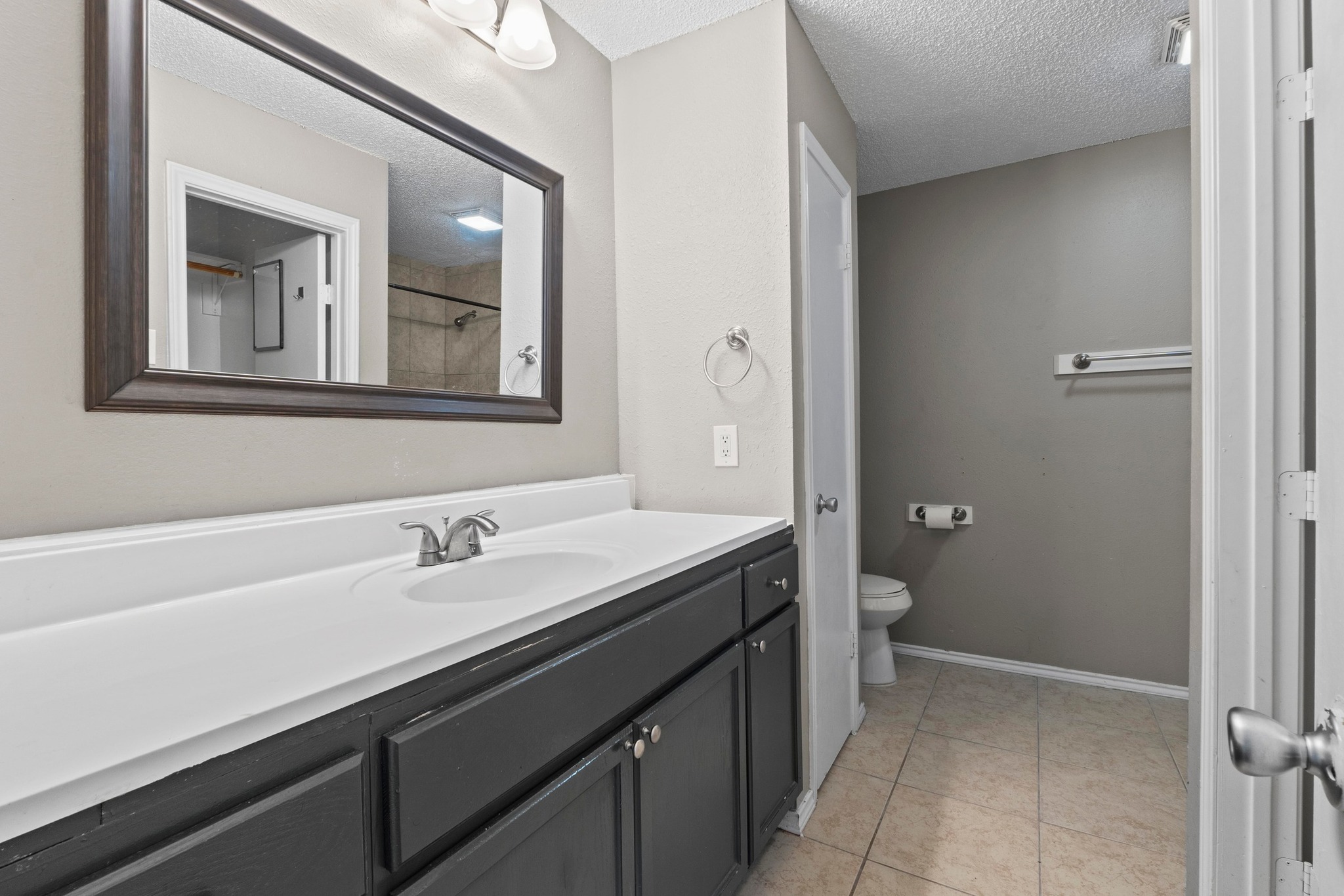 4208 Duval Road, Unit C Austin, TX 78759 - Photo 15 of 28 Full bath featuring vanity, a textured ceiling, and tile patterned flooring