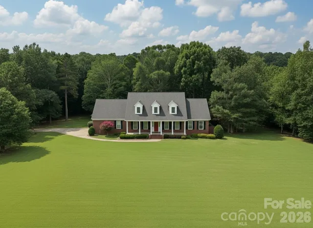 a view of a dining room with furniture wooden floor and chandelier