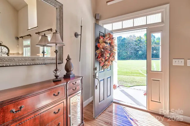 a view of a room with wooden floor and windows