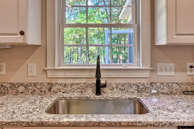 a view of hallway with stairs and wooden floor