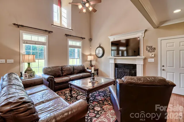 a living room with furniture and a chandelier