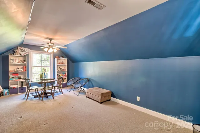 a view of a livingroom with furniture and chandelier
