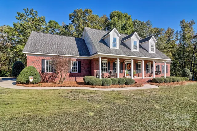 a front view of a house with garden and porch