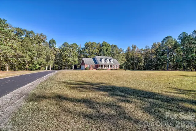 a kitchen with granite countertop cabinets stainless steel appliances and a window