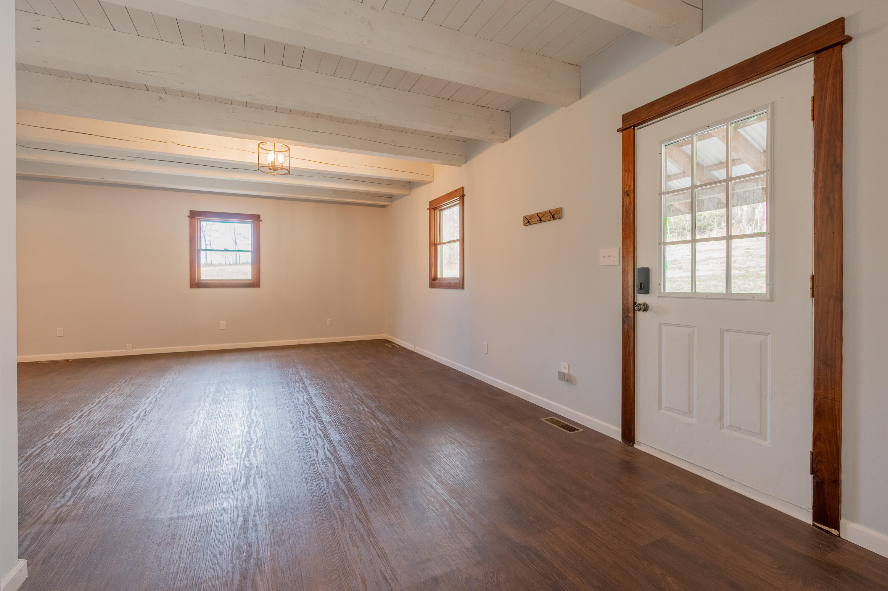 1133 Countyline Church Road Southeast Floyd, VA 24091 - Photo 21 of 97 an empty room with wooden floor and windows