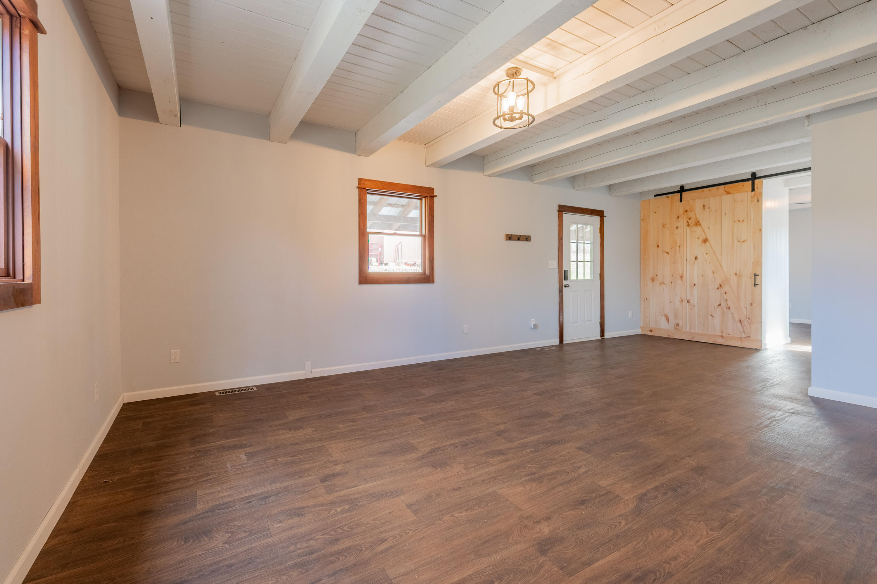 1133 Countyline Church Road Southeast Floyd, VA 24091 - Photo 24 of 97 an empty room with wooden floor and windows