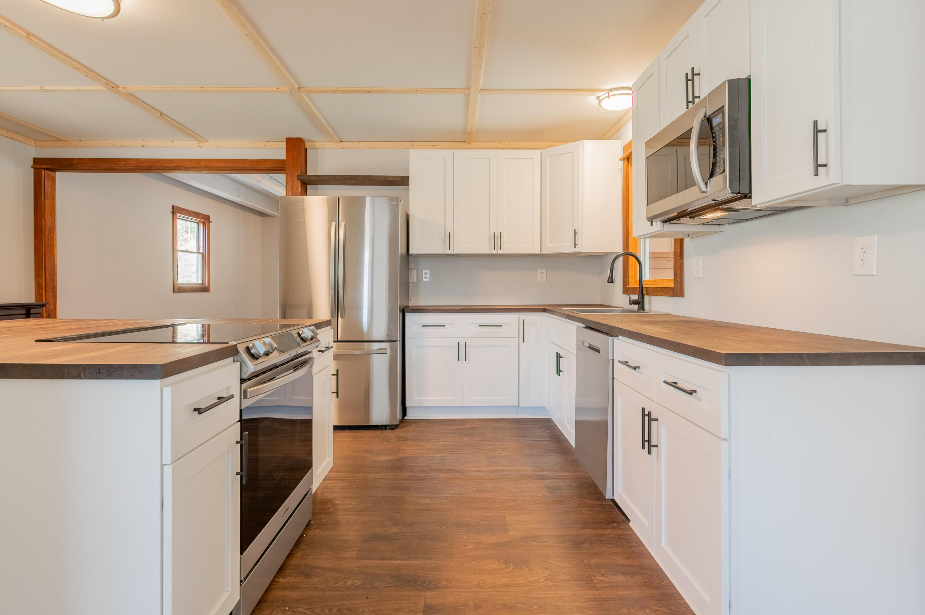 1133 Countyline Church Road Southeast Floyd, VA 24091 - Photo 31 of 97 a kitchen with stainless steel appliances granite countertop a stove top oven a sink and dishwasher