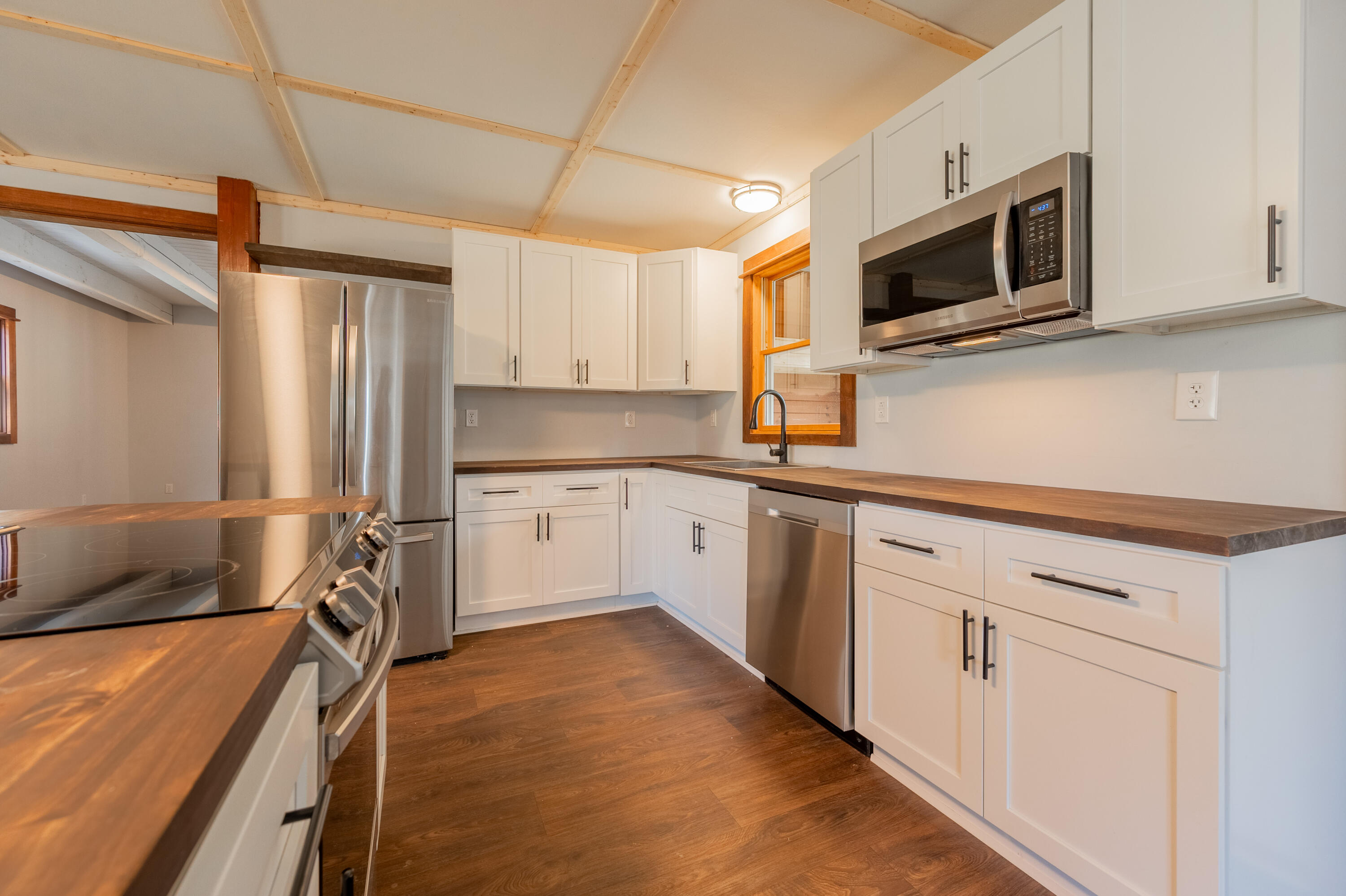 1133 Countyline Church Road Southeast Floyd, VA 24091 - Photo 32 of 97 a kitchen with stainless steel appliances a stove microwave and sink