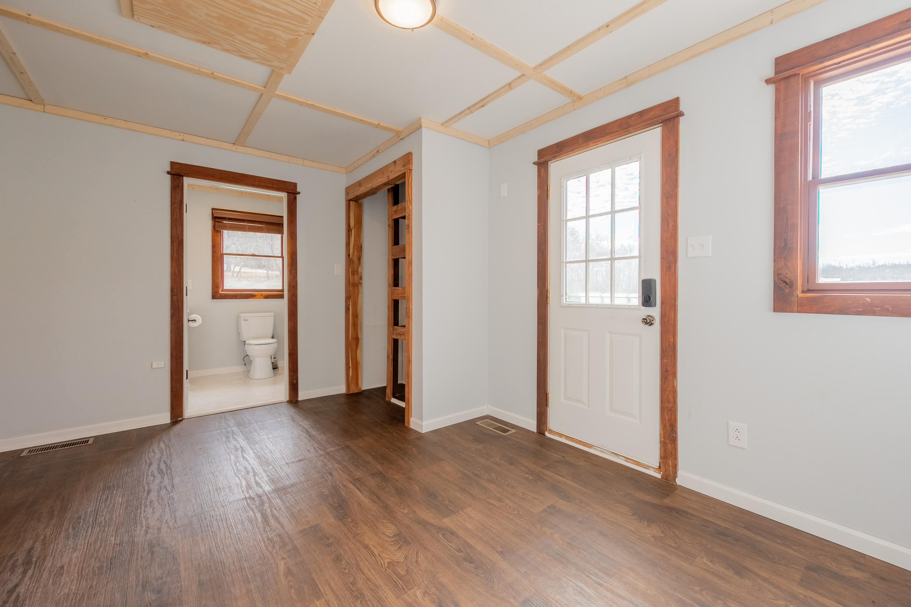 1133 Countyline Church Road Southeast Floyd, VA 24091 - Photo 35 of 97 an empty room with wooden floor and windows