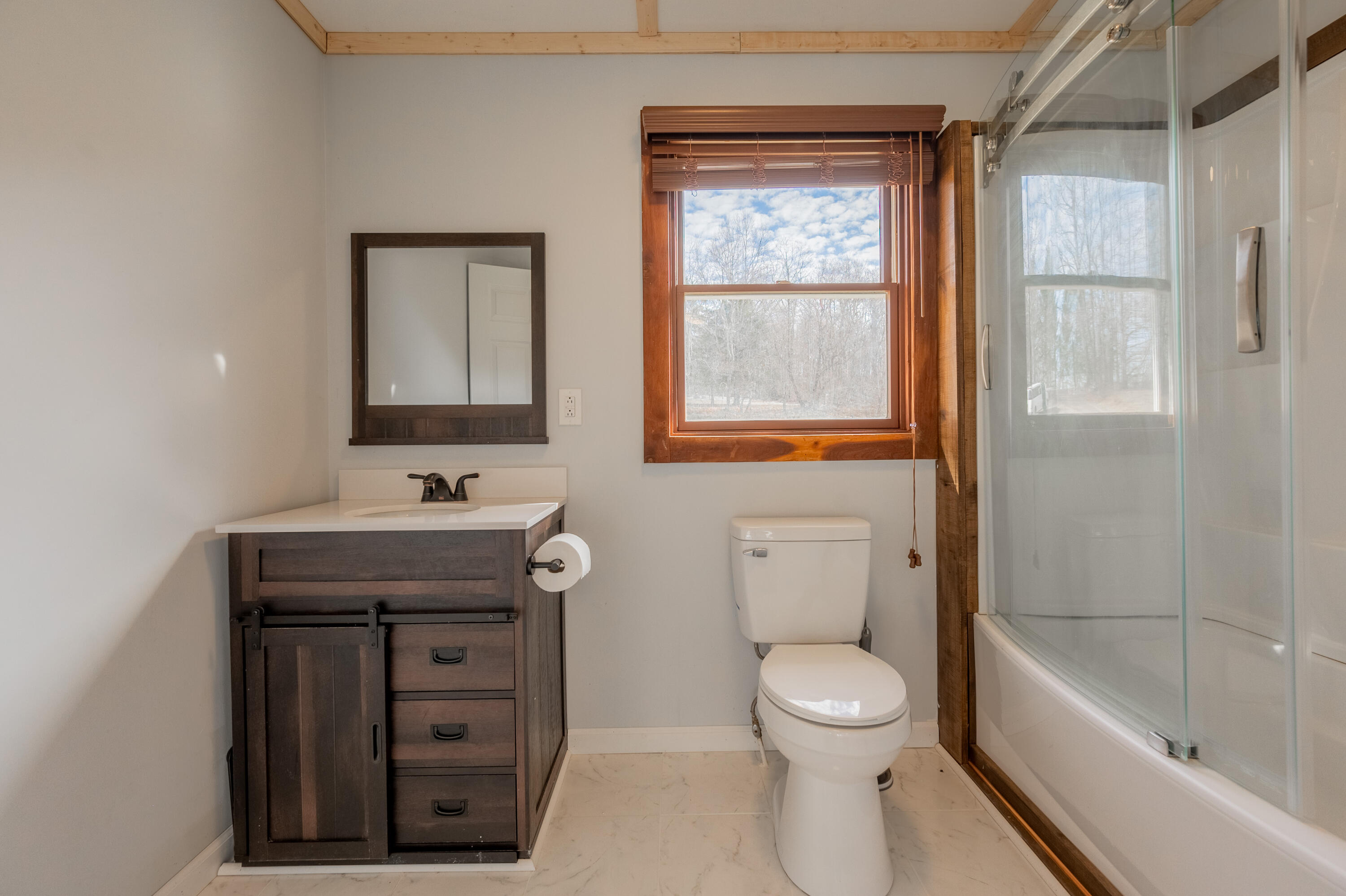 1133 Countyline Church Road Southeast Floyd, VA 24091 - Photo 36 of 97 a bathroom with a granite countertop toilet a sink a mirror and a bathtub