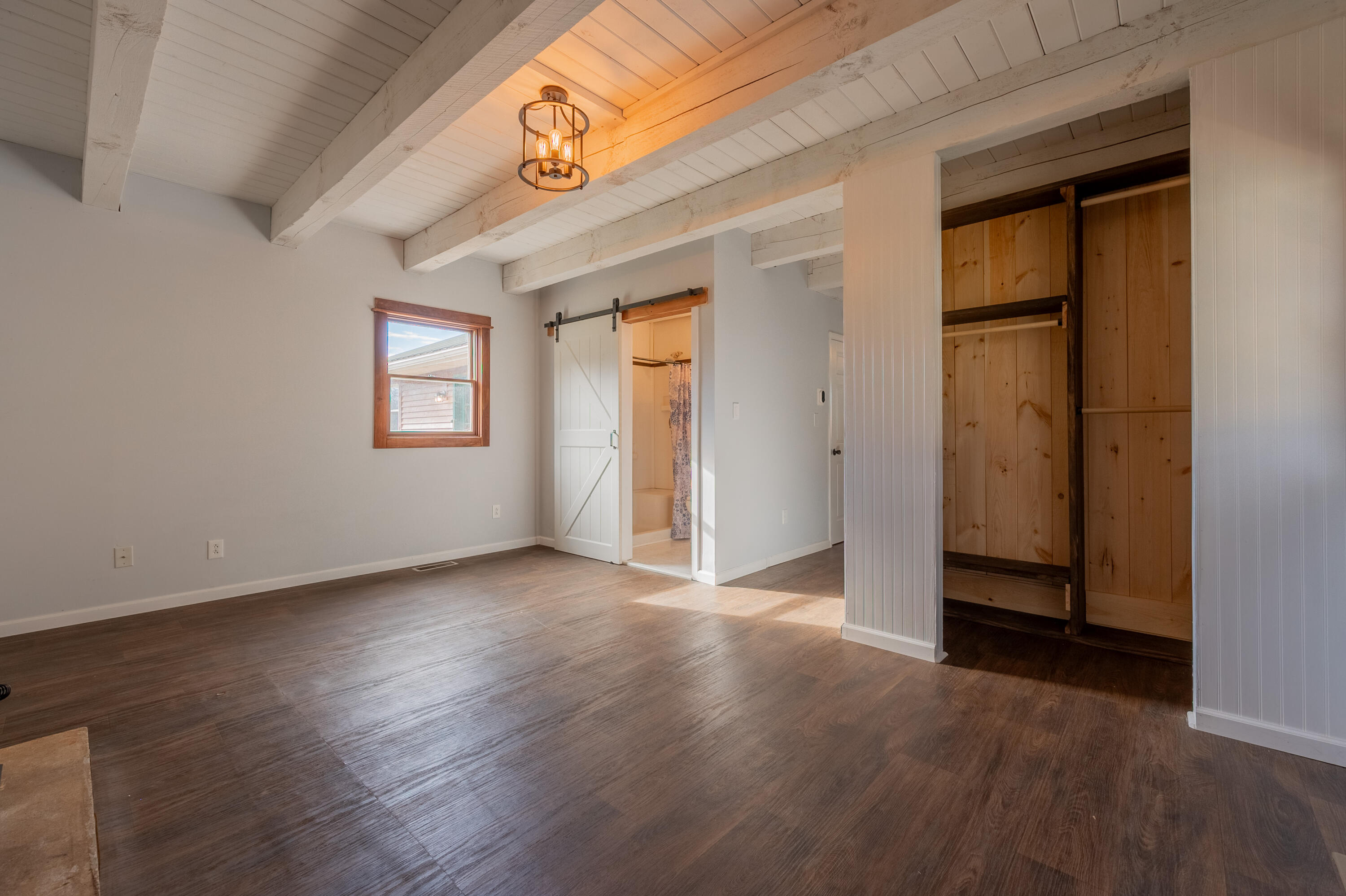 1133 Countyline Church Road Southeast Floyd, VA 24091 - Photo 46 of 97 an empty room with wooden floor and windows
