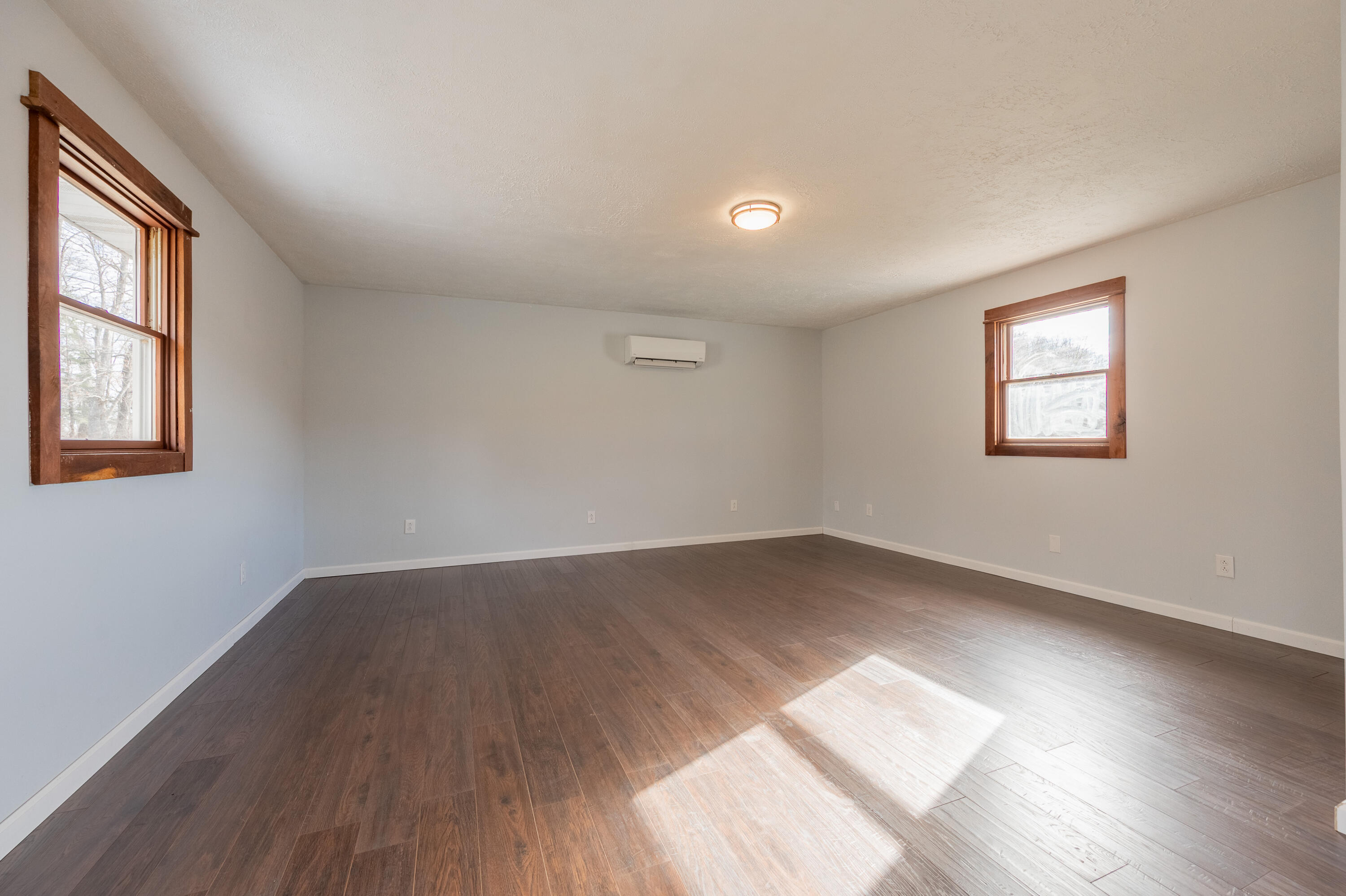 1133 Countyline Church Road Southeast Floyd, VA 24091 - Photo 52 of 97 an empty room with wooden floor and windows