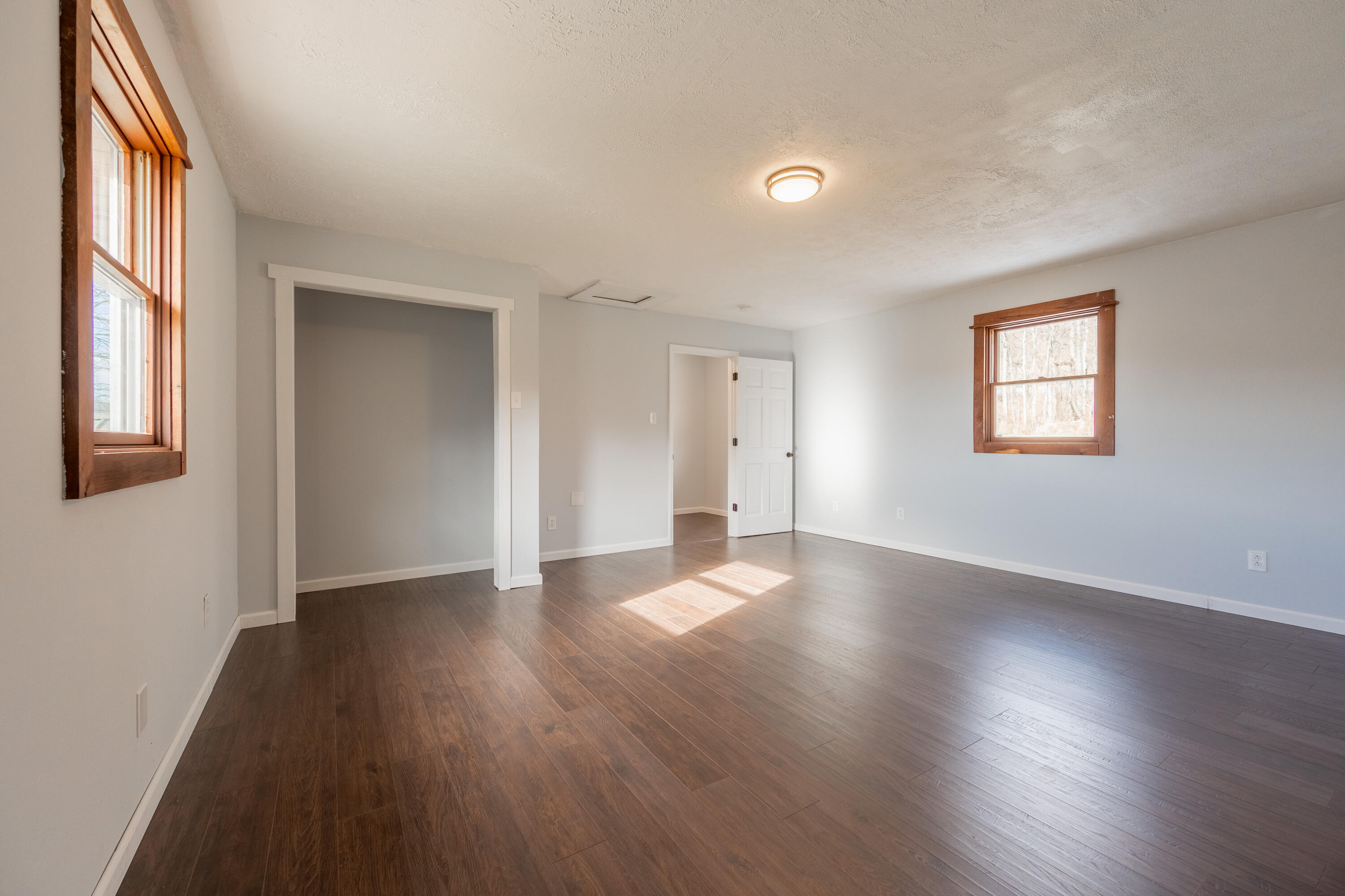 1133 Countyline Church Road Southeast Floyd, VA 24091 - Photo 54 of 97 an empty room with wooden floor and windows