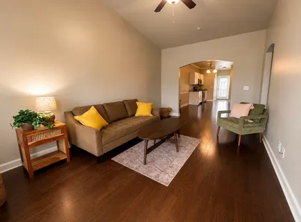 a living room with furniture and wooden floor