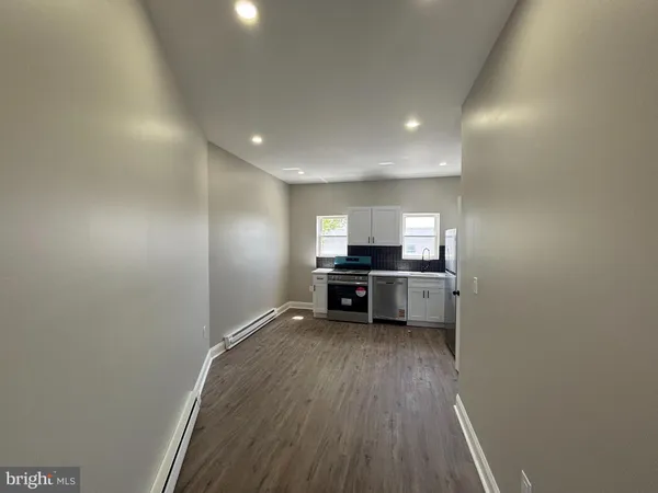 a kitchen with stainless steel appliances a refrigerator and a stove top oven