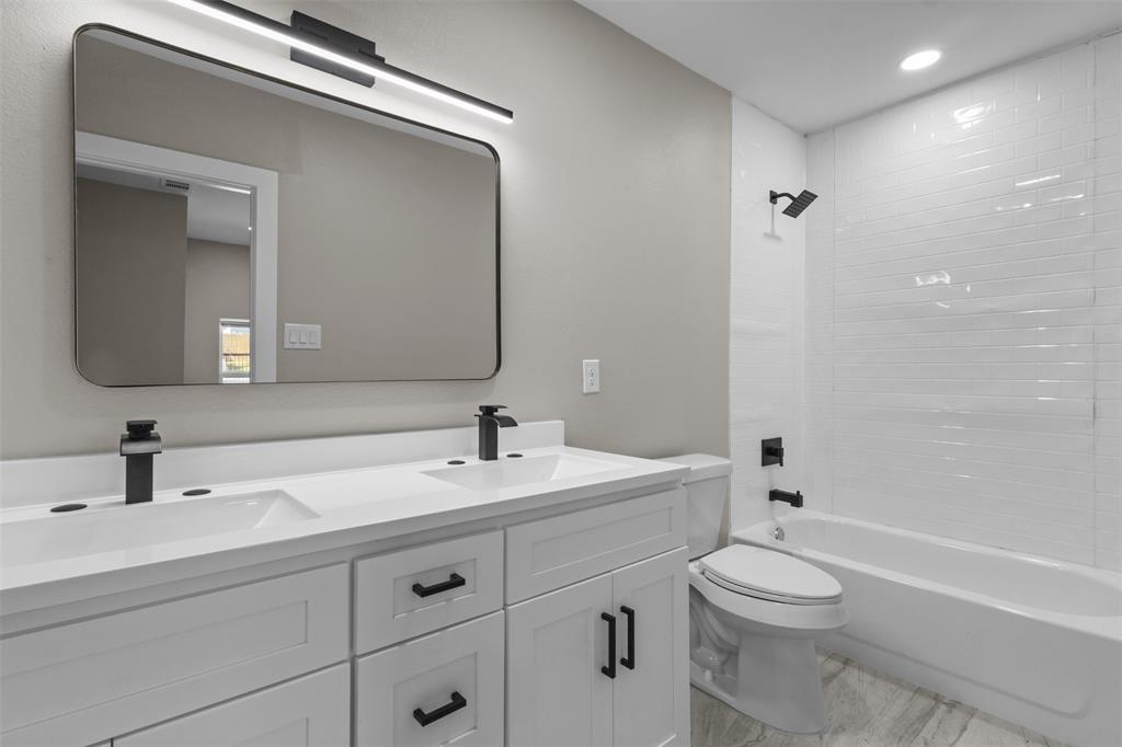 1903 Beauford Road Dallas, TX 75253 - Photo 13 of 27 Double vanity with white cabinetry and matte black hardware