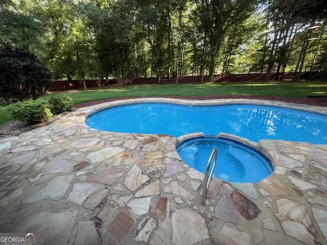 558 Kenwood Road Fayetteville, GA 30214 - Photo 32 of 33 a view of a swimming pool with a yard and trees