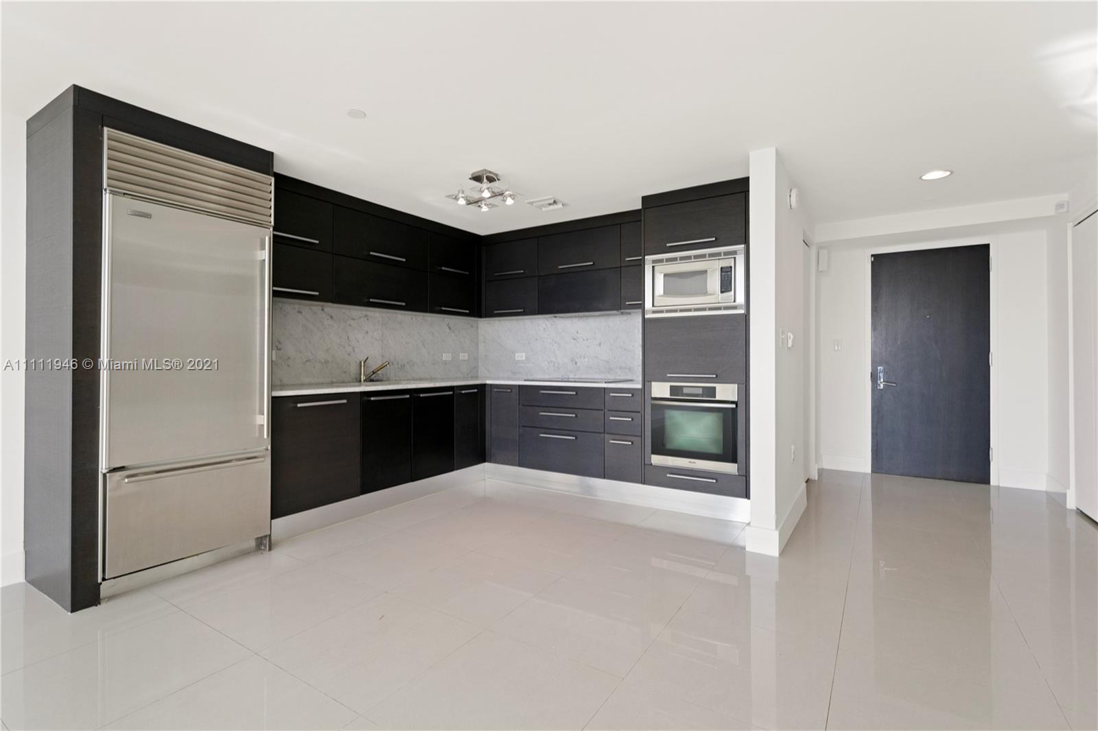 900 Biscayne Boulevard, Unit 507 Miami, FL 33132 - Photo 15 of 20 a kitchen with stainless steel appliances a refrigerator and a stove