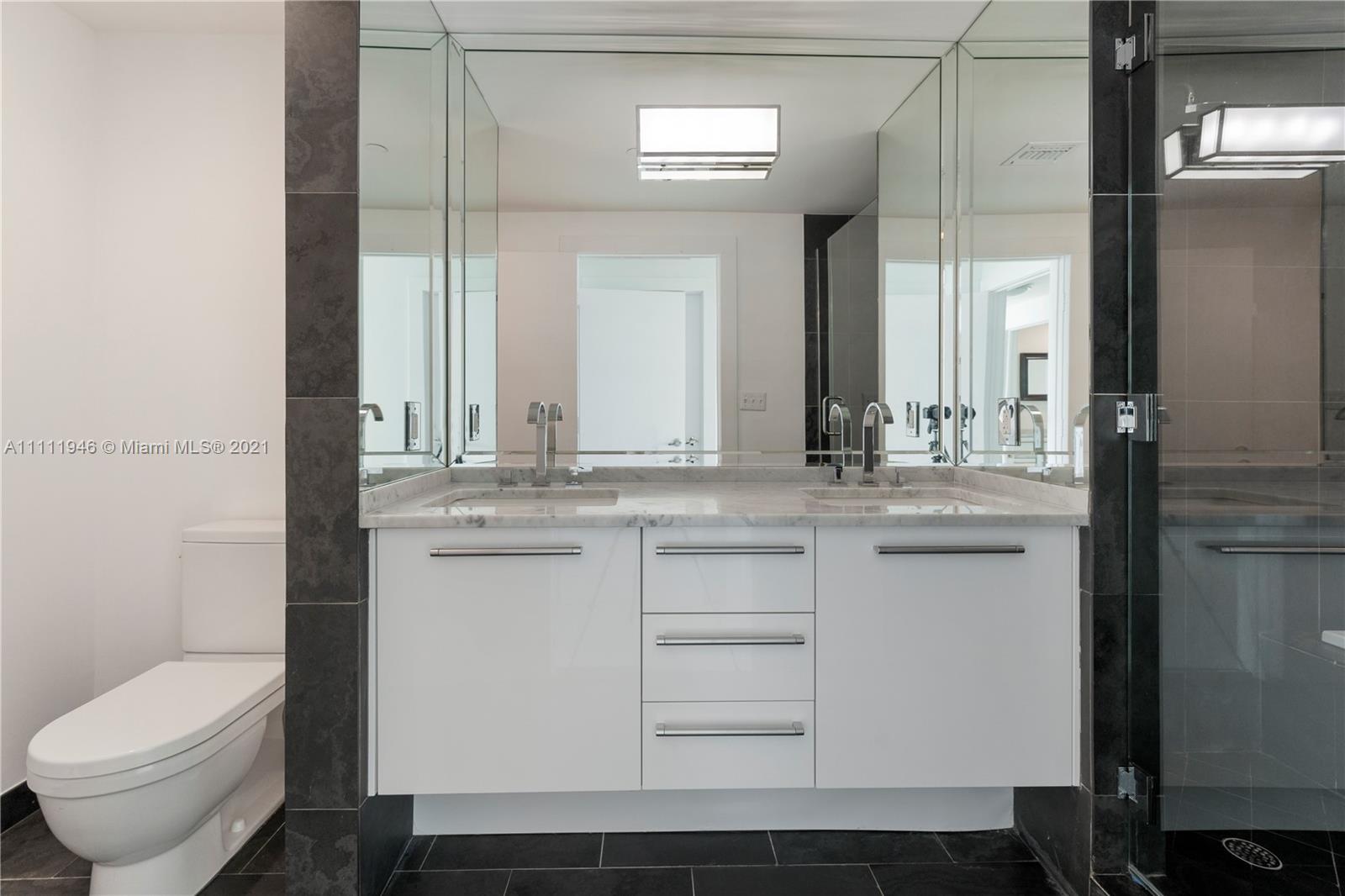 900 Biscayne Boulevard, Unit 507 Miami, FL 33132 - Photo 5 of 20 a bathroom with a sink toilet and mirror