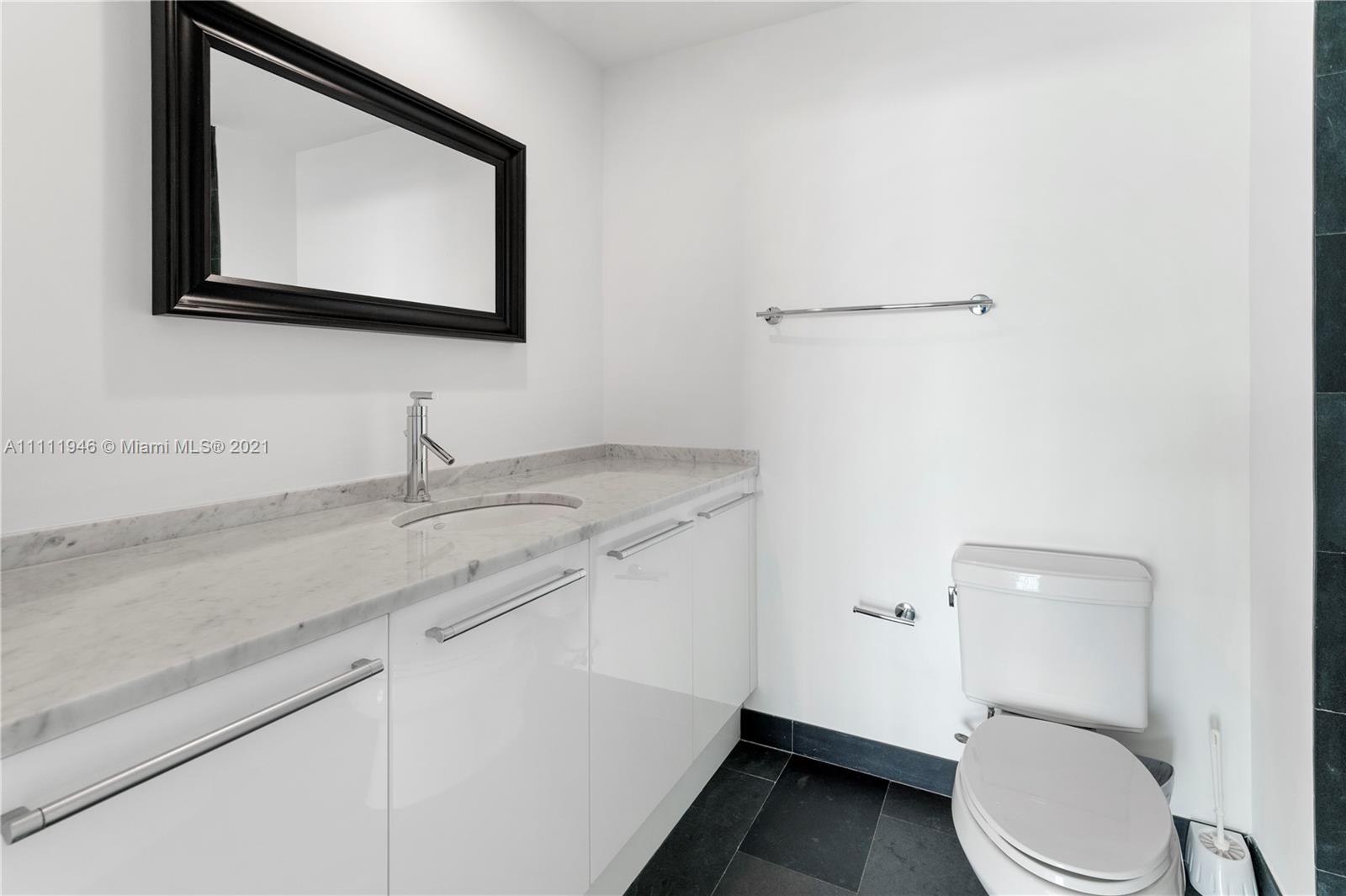 900 Biscayne Boulevard, Unit 507 Miami, FL 33132 - Photo 6 of 20 a bathroom with a toilet sink and mirror