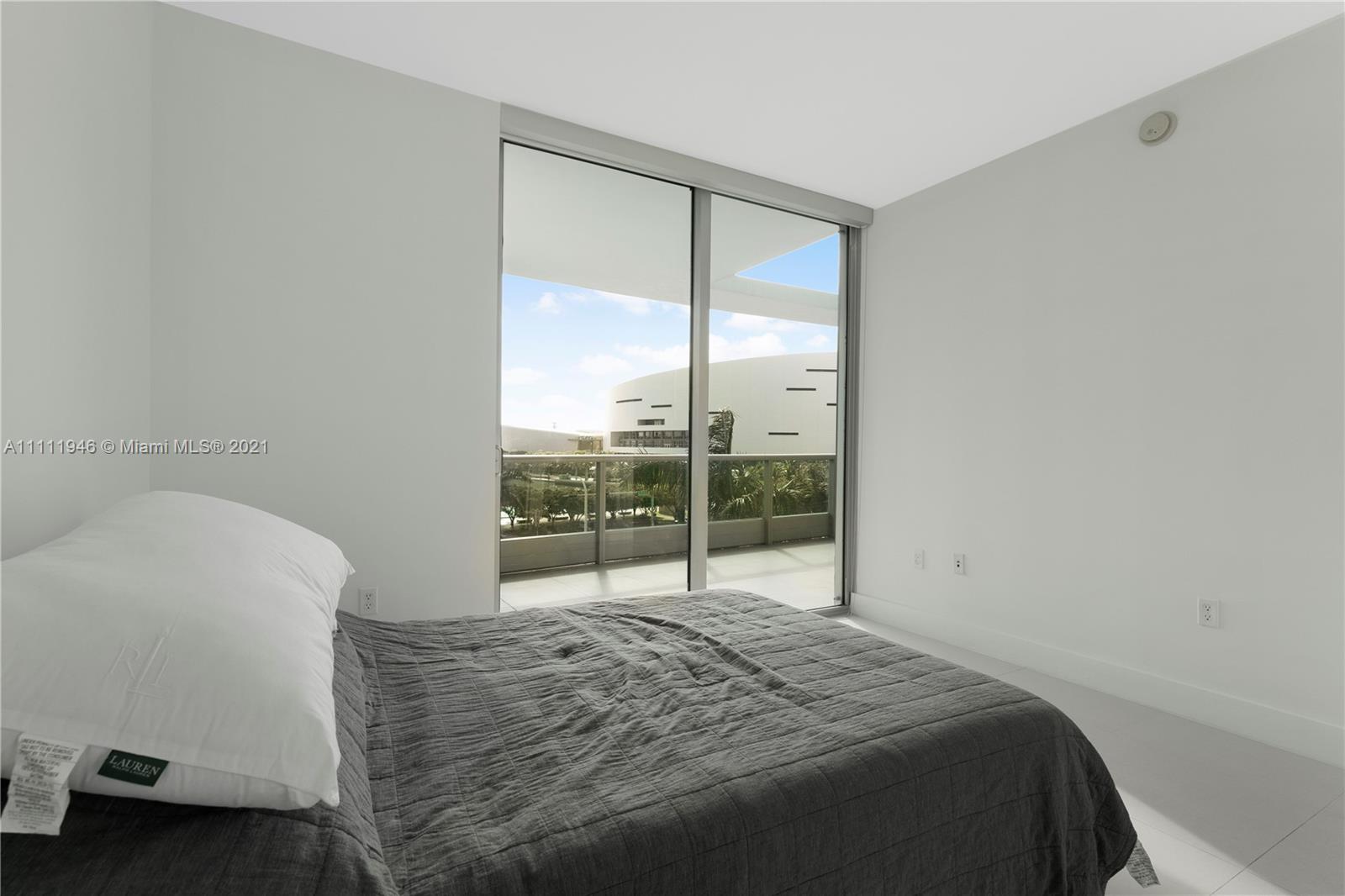 900 Biscayne Boulevard, Unit 507 Miami, FL 33132 - Photo 9 of 20 a bedroom with a bed and a window
