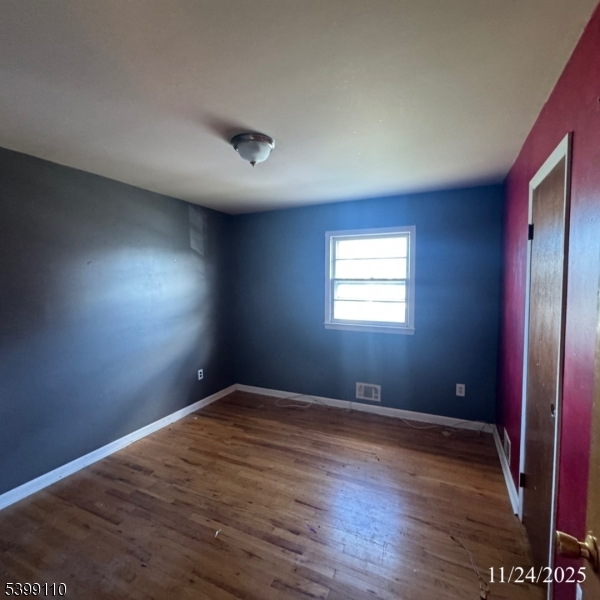 2659 Hawthorne Avenue Union, NJ 07083 - Photo 12 of 12 an empty room with wooden floor and windows
