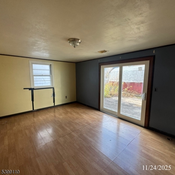 2659 Hawthorne Avenue Union, NJ 07083 - Photo 3 of 12 an empty room with wooden floor and door