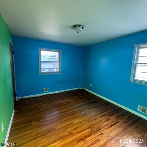 2659 Hawthorne Avenue Union, NJ 07083 - Photo 10 of 12 an empty room with wooden floor and windows