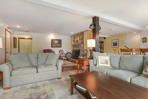 a living room with furniture and a chandelier