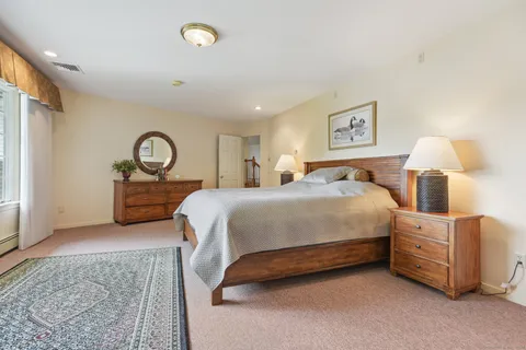 a bedroom with a bed and a lamp