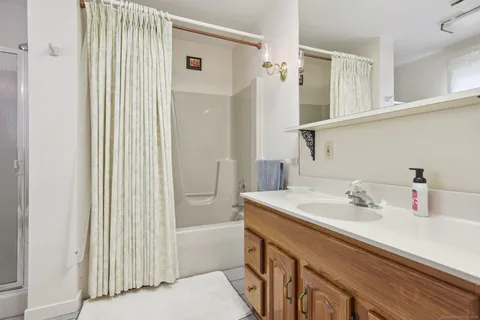 a bathroom with a sink a mirror and shower