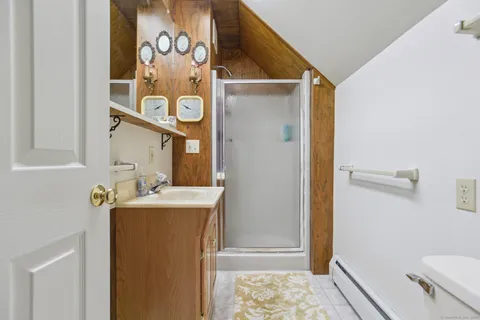 a bathroom with a sink and mirror with toilet