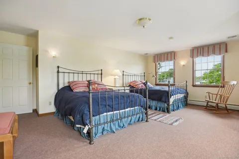 a bedroom with two beds and a window