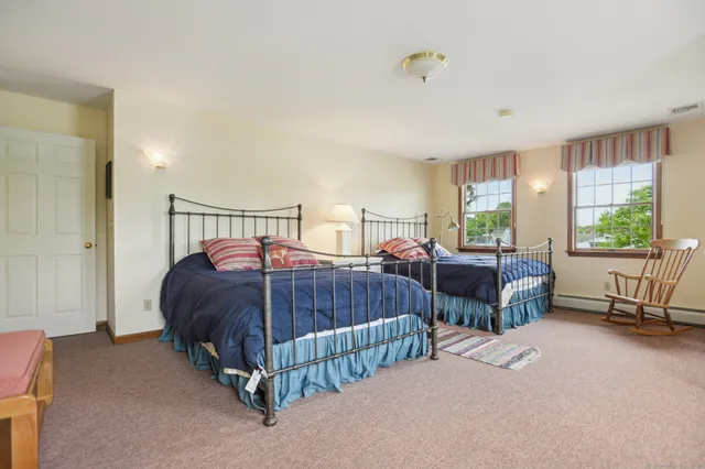 a bedroom with two beds and a window