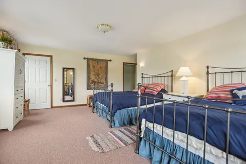 a bedroom with two beds and a lamp