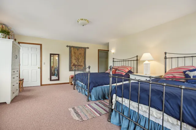 a bedroom with two beds and a lamp