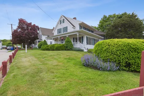 a front view of a house with a garden