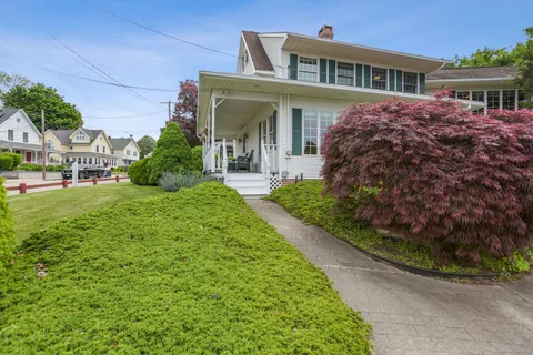 a front view of a house with a garden