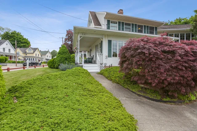 a front view of a house with a garden