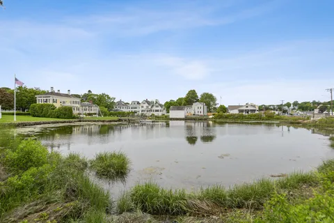 a view of a lake with houses in the back