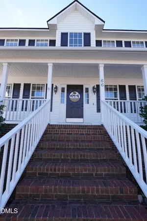 a front view of a house with wooden stairs