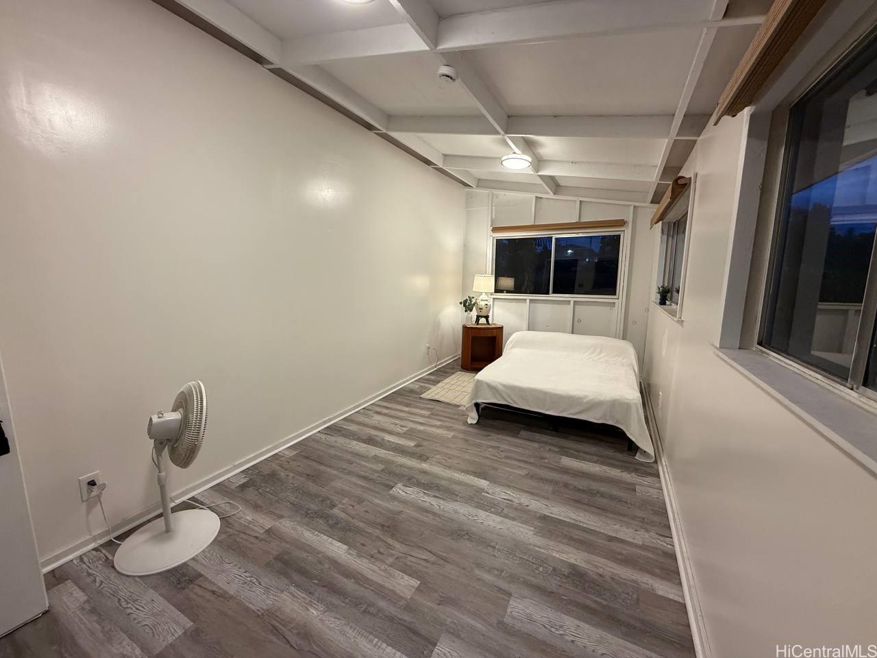 82 Hoku Street, Unit D Hilo, HI 96720 - Photo 11 of 15 a bedroom with a bed and a flat screen tv