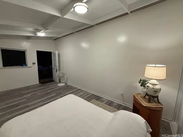 a bedroom with a bed and a tv