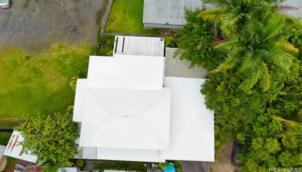 an aerial view of a house with a yard and garden